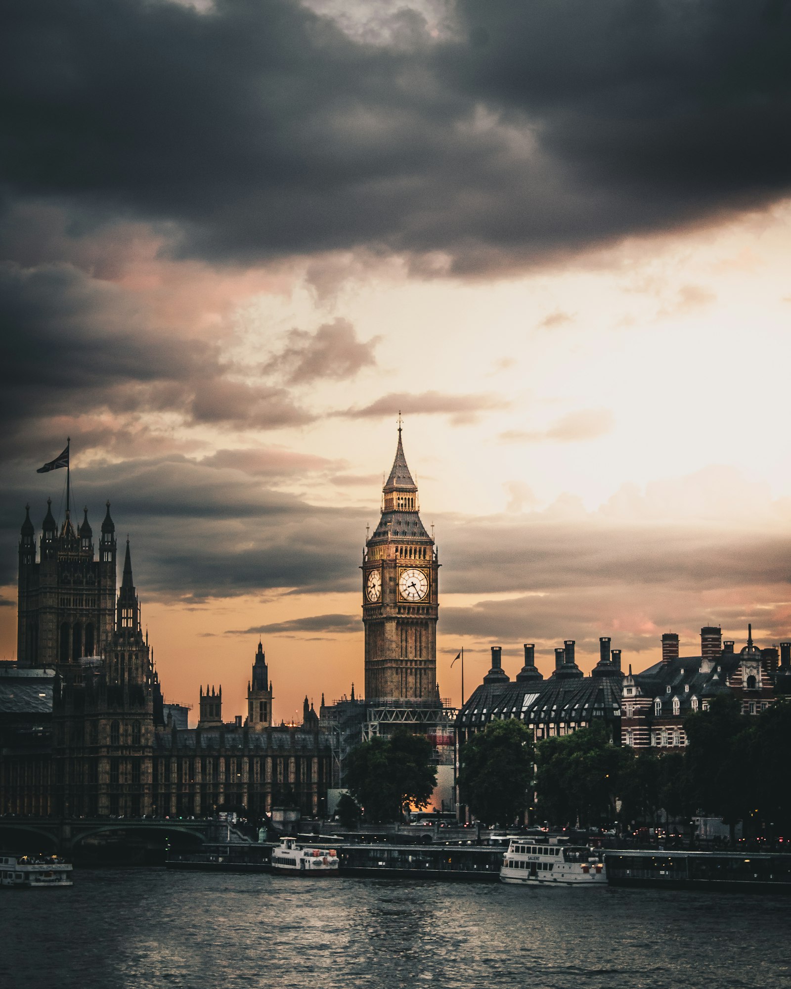 Red double-decker bus crossing Westminster Bridge in London with Big Ben behind