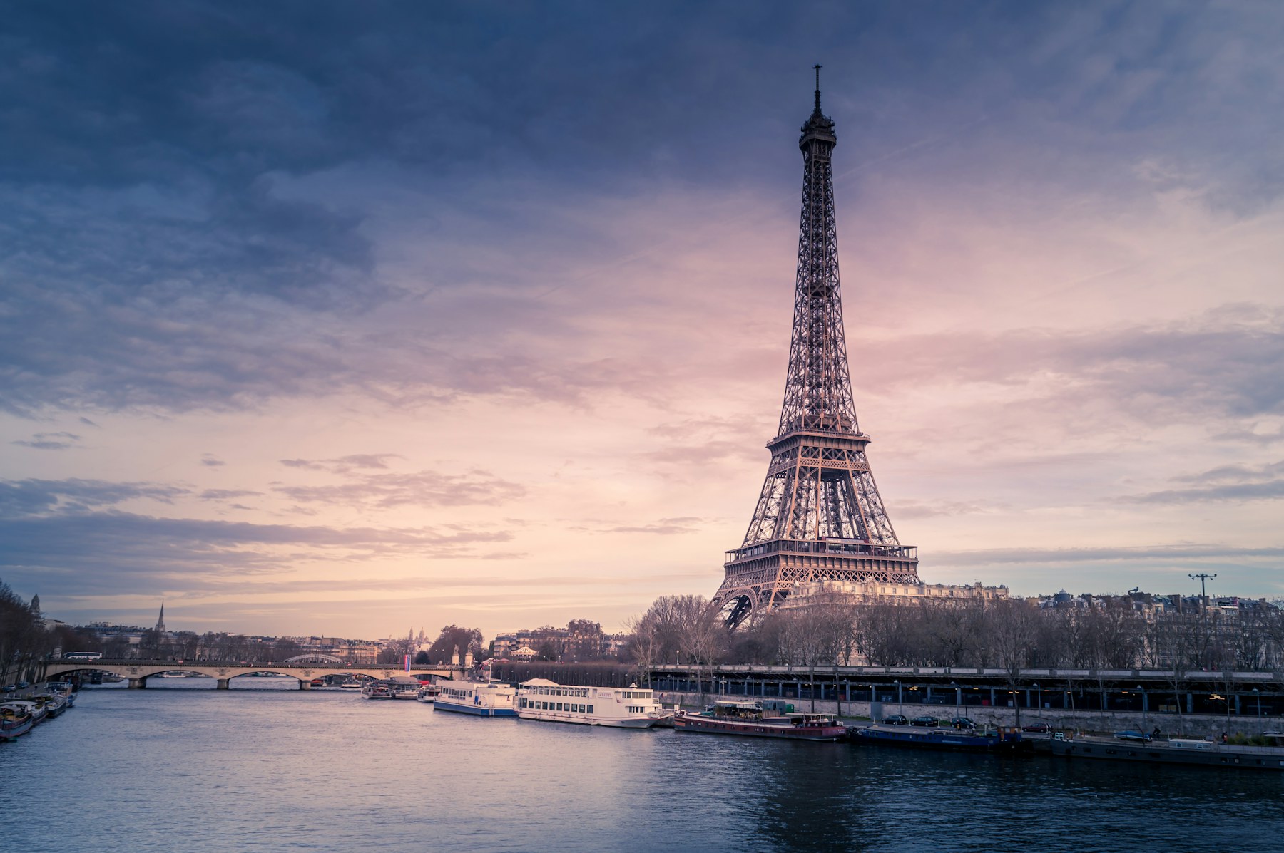 The Eiffel Tower and the Seine at dusk on a Paris graduation trip